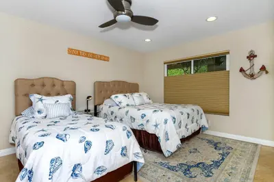 a bedroom with two beds and a ceiling fan at 5N-53 Beach Bliss Ocean Views in Oceanside