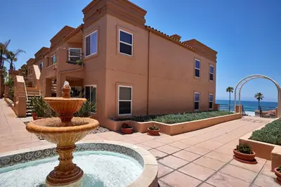 a large house with a fountain in front of a building at 501P-5 Panoramic Ocean & Pier Views in Oceanside