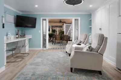 a living room with blue walls and a couch and chairs at Suite with Rooftop Deck and Ocean Views in Mission Bay in San Diego