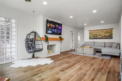 a living room with a couch and a fireplace at Spectacular Coastal Farmhouse 4BR in Ocean Beach in San Diego