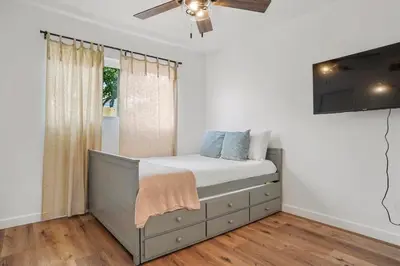 a bedroom with a bed and a ceiling fan at Spectacular Coastal Farmhouse 4BR in Ocean Beach in San Diego
