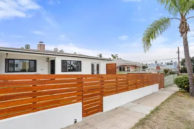 a wooden fence in front of a house at Spectacular Coastal Farmhouse 4BR in Ocean Beach in San Diego