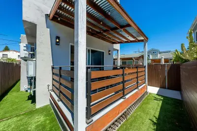 a balcony with a wooden fence and grass at Stylish Studio with Big Patio in San Diego