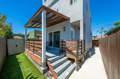 a porch of a house with a wooden railing at Stylish Studio with Big Patio in San Diego