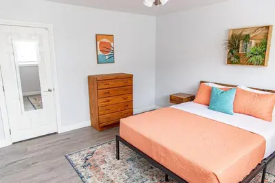 a bedroom with an orange bed and a dresser at Vibrant Imperial Beach Oasis in Imperial Beach