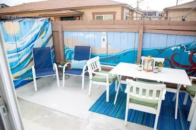 a patio with a table and chairs and a mural at Vibrant Imperial Beach Oasis in Imperial Beach