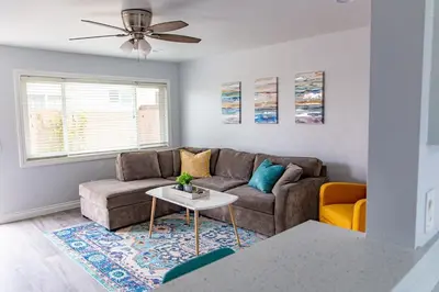 a living room with a couch and a table at Vibrant Imperial Beach Oasis in Imperial Beach