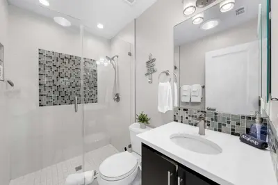 a bathroom with a toilet and a sink and a shower at Relaxing Beach Bungalow in San Diego