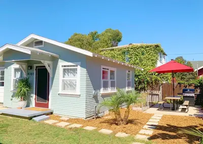 a small house with a red umbrella in the yard at Adorable Quirky Hideaway BIG Private Enclosed Yard in San Diego