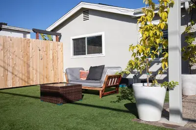 a backyard with a chair on the grass at The Atlas in San Diego