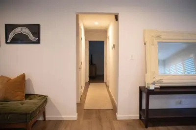 a living room with a couch and a hallway at The Atlas in San Diego