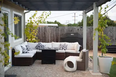 a patio with a couch and two chairs and a table at The Atlas in San Diego