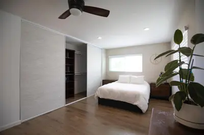 a bedroom with a bed and a ceiling fan at The Atlas in San Diego