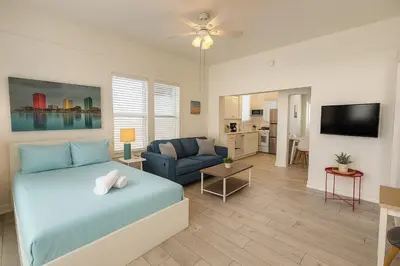 a bedroom with a bed and a living room at Urban Nest with private Patio in Golden Hill - walk everywhere! in San Diego