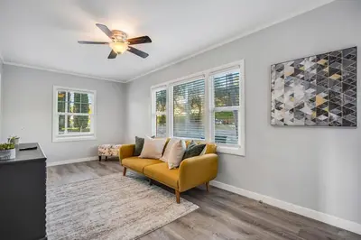 a living room with a couch and a ceiling fan at 1BD Remodeled Craftsman Cottage Free parking Heart of lIttle Italy in San Diego