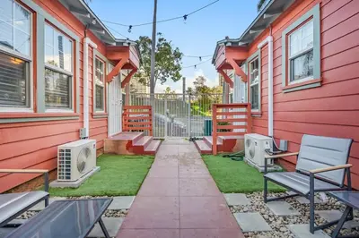 a walkway in front of a red building at 1BD Remodeled Craftsman Cottage Free parking Heart of lIttle Italy in San Diego