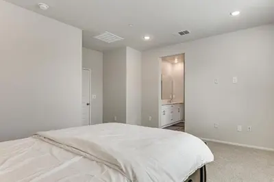 a white bedroom with a bed and a tv at Near Hospitals Home with Pool Access in Temecula in Temecula