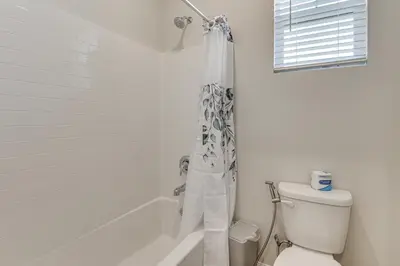 a bathroom with a toilet and a shower curtain at Near Hospitals Home with Pool Access in Temecula in Temecula