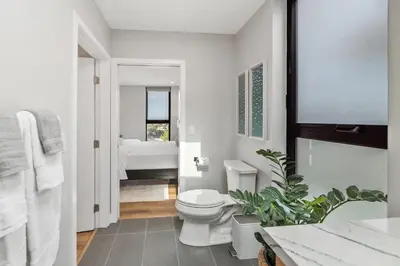 a white bathroom with a toilet and a sink at Designer Canyon House in La Jolla in San Diego