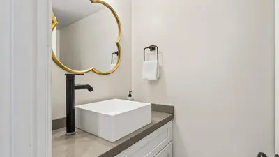 a bathroom with a white sink and a mirror at Steps to the Beach Hot Tub Fire Pit 257 Trailhead Trestles 2 by AvantStay in San Clemente