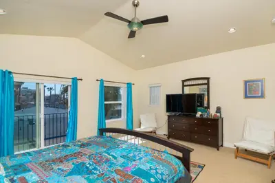 a bedroom with a bed and a ceiling fan at Oceanview Beach Home - 209W in Oceanside