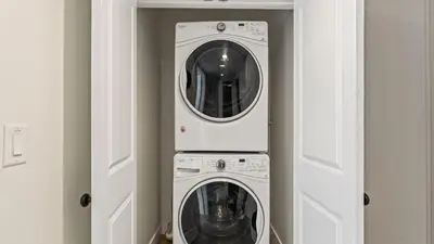 two washing machines are in a white room at 2 Condos Steps to the Beach Hot Tub Trestles Trailhead Duo by AvantStay in San Clemente