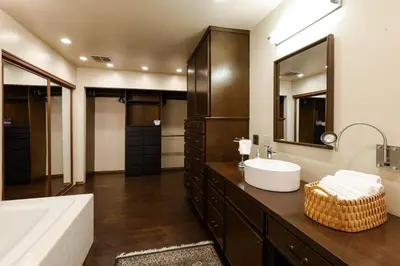 a bathroom with a sink and a large mirror at Bridgeview Retreat Near Balboa Park in San Diego