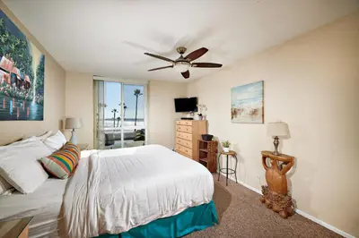 a bedroom with a bed and a ceiling fan at North Coast Village D204 in Oceanside