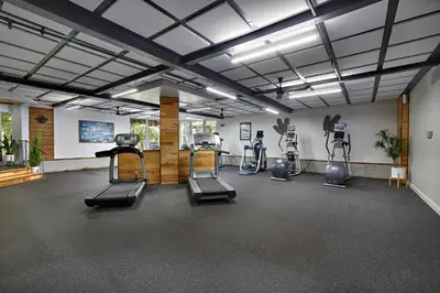 a gym with treadmills and ellipticals in a room at North Coast Village D204 in Oceanside