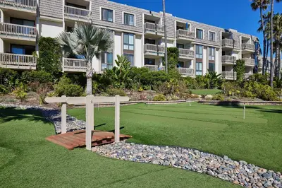 a large apartment building with a tennis court in front of it at North Coast Village D204 in Oceanside