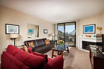 a living room with a couch and a fireplace at North Coast Village D204 in Oceanside