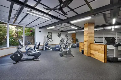 a gym with treadmills and exercise bikes in a room at North Coast Village D204 in Oceanside