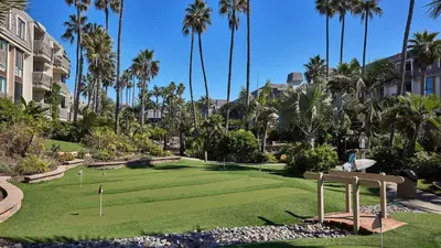 a golf course in the middle of a resort with palm trees at North Coast Village Cottage G20 in Oceanside