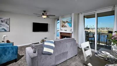 a living room with a couch and a television at North Coast Village Cottage G20 in Oceanside