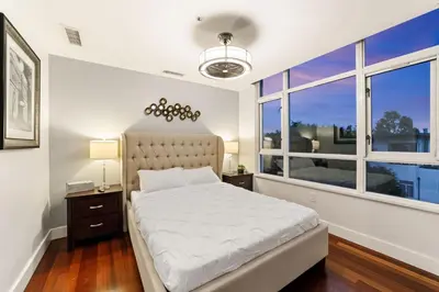 a bedroom with a bed and a large window at 3BR Downtown Peaceful Corner in San Diego