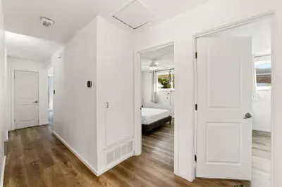 a white room with a bed and a door at Casa Malta Spa and Pool in San Diego