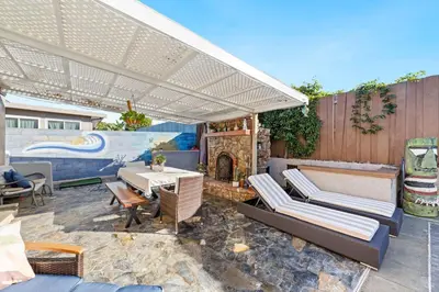 a patio with a table and chairs and a fireplace at Casa Malta Spa and Pool in San Diego