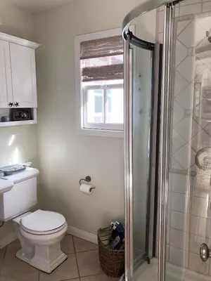 a bathroom with a toilet and a shower at La Jolla Beach Cottage in San Diego
