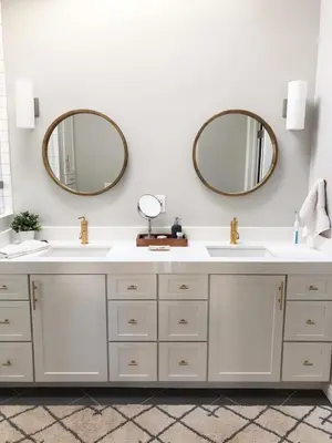 a bathroom with two sinks and two mirrors at La Jolla Beach Cottage in San Diego