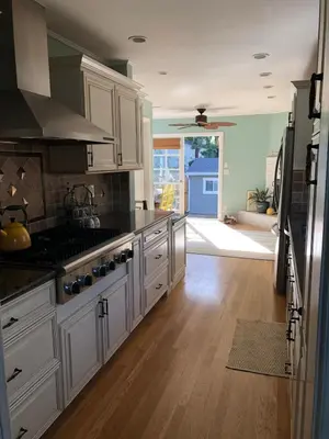 a kitchen with white cabinets and a stove top oven at La Jolla Beach Cottage in San Diego