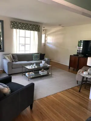 a living room with a couch and a table at La Jolla Beach Cottage in San Diego