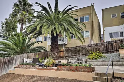 a palm tree in front of a building at Cozy Apt W Patio Bankers Hill SD in San Diego