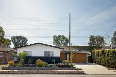 a house with a black and white garage at Artist micro-villa with kitchen, firepit & theater in San Diego