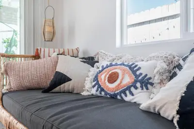 a couch with pillows on it in a living room at Artist micro-villa with kitchen, firepit & theater in San Diego