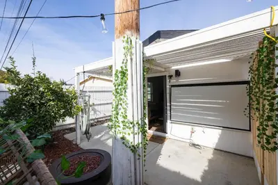 a garage door with ivy on the side of a house at Artist micro-villa with kitchen, firepit & theater in San Diego