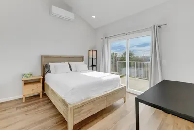 a bedroom with a bed and a desk and a window at Bright Spacious Modern Getaway in San Diego