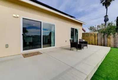a patio with chairs and a large window at Bright Spacious Modern Getaway in San Diego