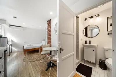 a bathroom with a toilet and a sink at Boho Little Italy Studio with Patio in San Diego