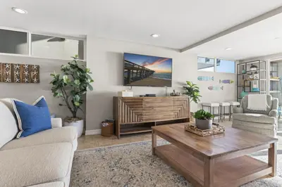a living room with a couch and a coffee table at Hawaiian Style Beachfront on Beach Road in Dana Point
