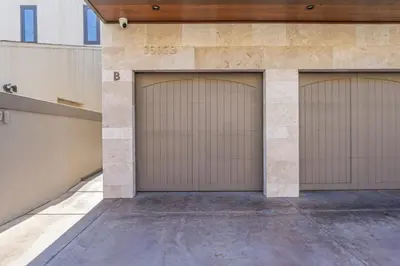 a pair of garage doors on a building at Hawaiian Style Beachfront on Beach Road in Dana Point